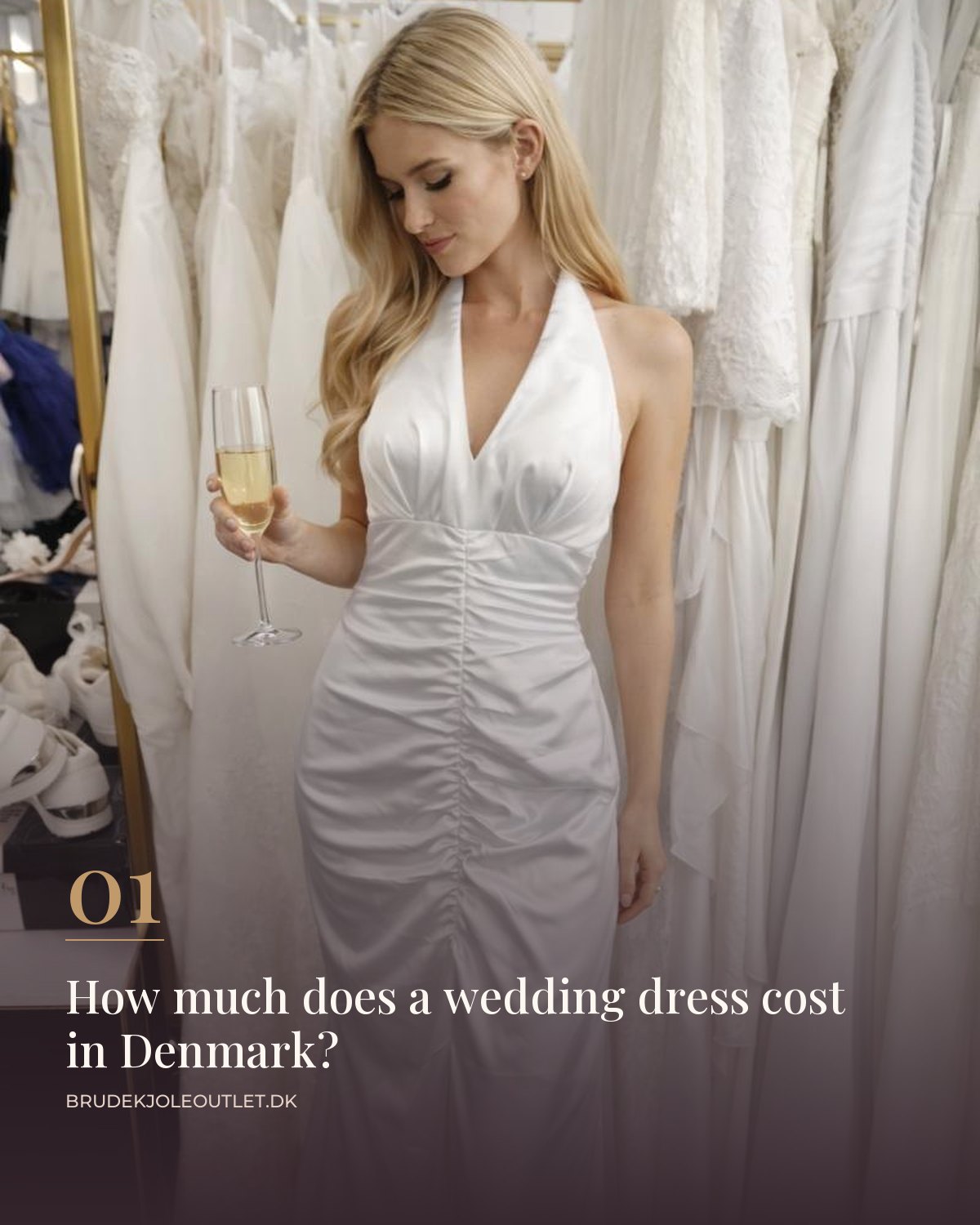 Bride in a white satin halterneck wedding dress with a draped bodice between rails of wedding dresses